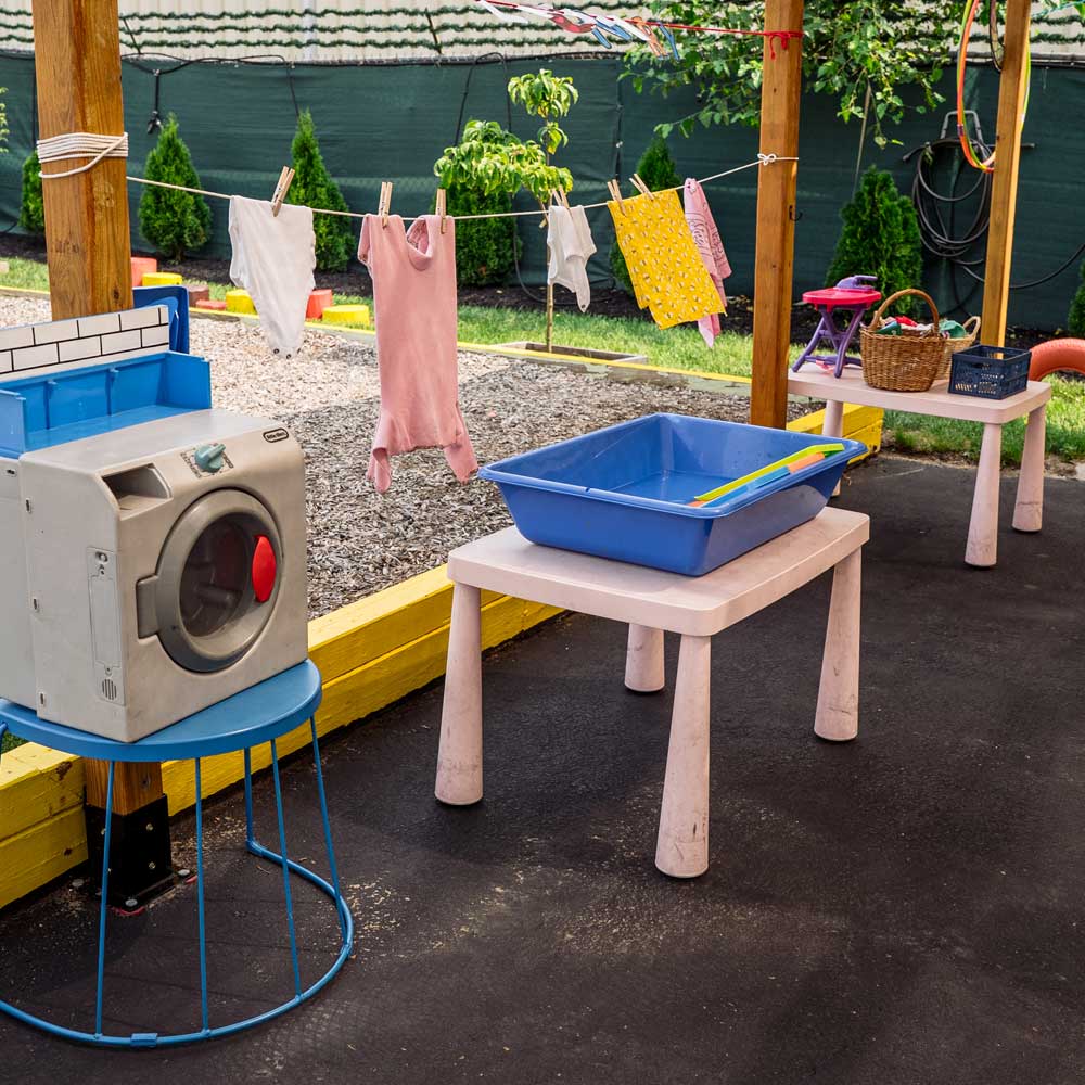 Pre-K outdoor laundry activity teaching practical-life skills at Baby Genius Daycare in Langhorne